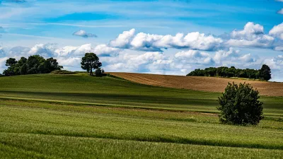 Glooiende akkers onder stapelwolken, de foto